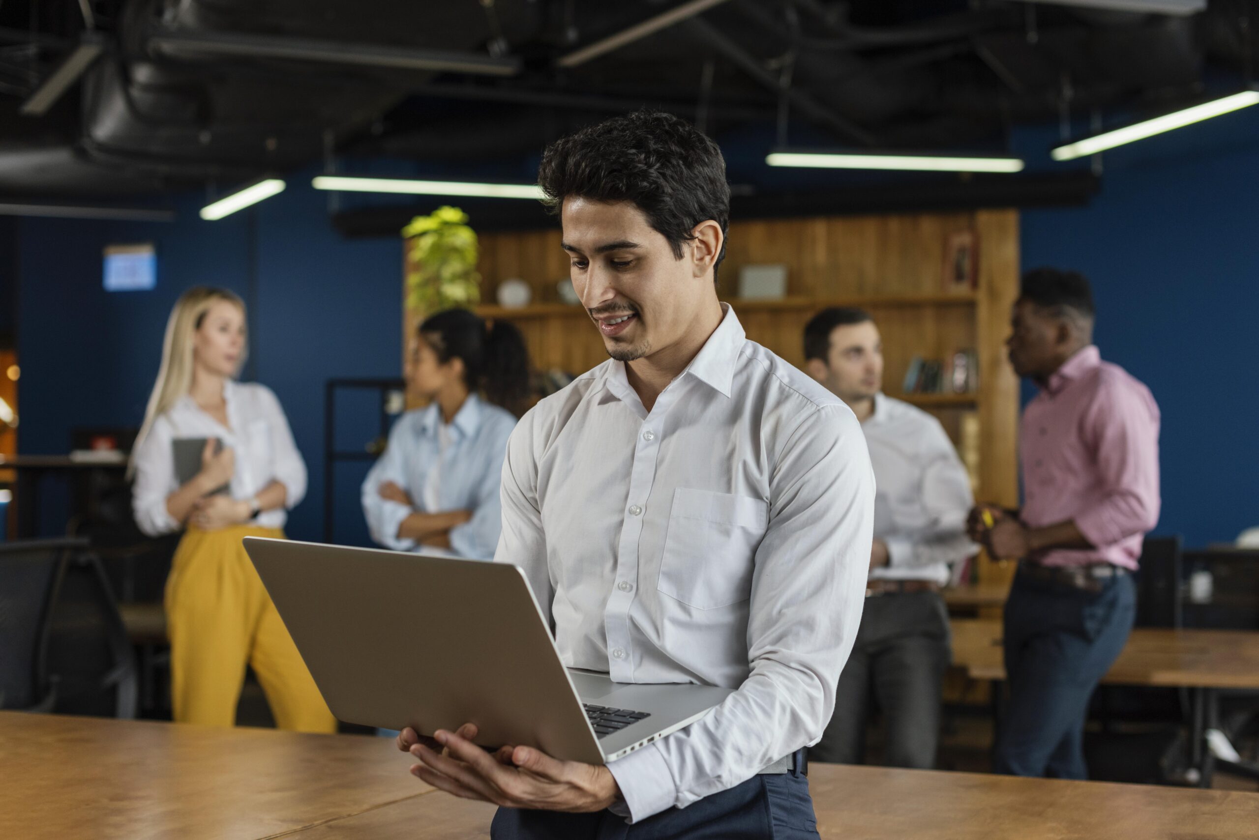 smiley-man-work-holding-laptop